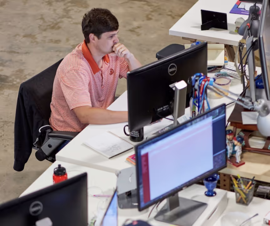 An Engineer at a computer working in a development environment.